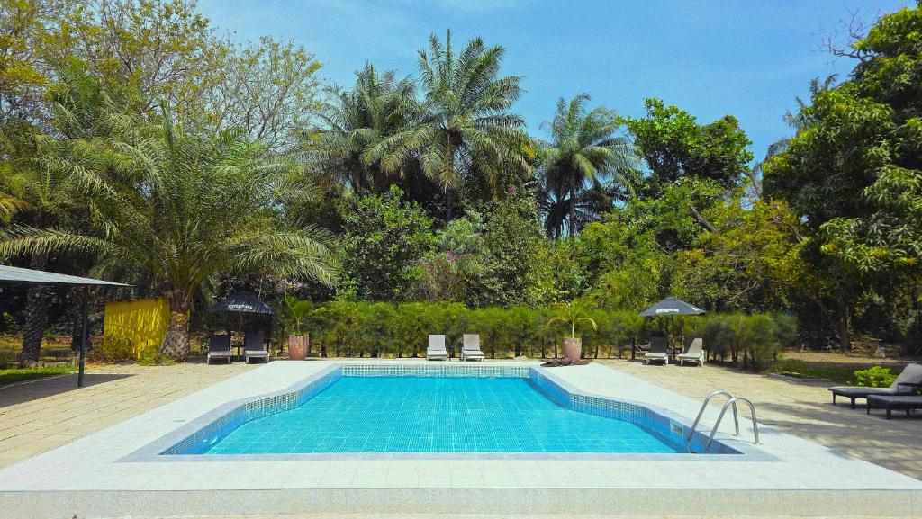 a swimming pool in the middle of a resort at Tendinkoto Lodge in Sanyang