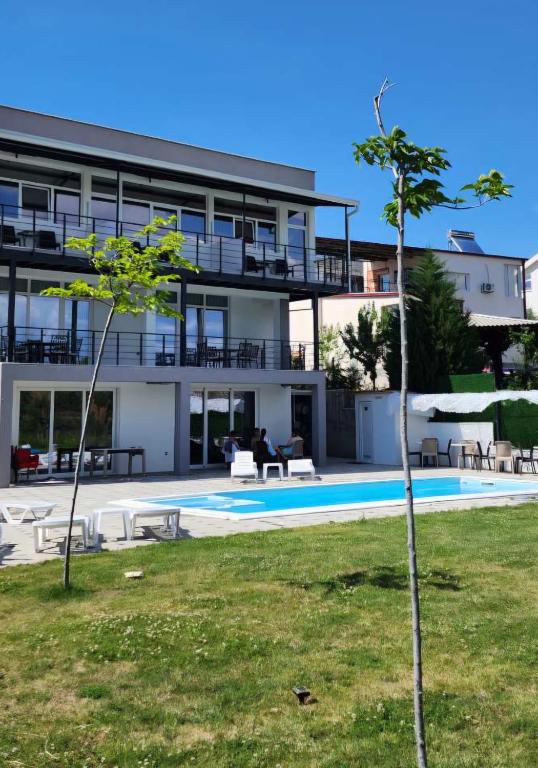 a large building with a swimming pool in front of it at Tashev Apartments in Veles