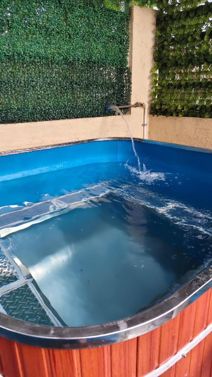 a pool of water with a water fountain at Gee Staycation in Santo Tomas
