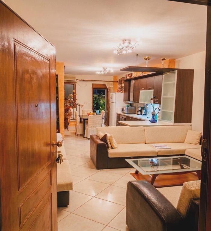 a living room with a couch and a table at Aqua Mare Seaside Experience in Pyrgadikia