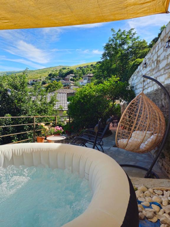 a swimming pool with a swing and a basket at Lemon Garden in Gjirokastër