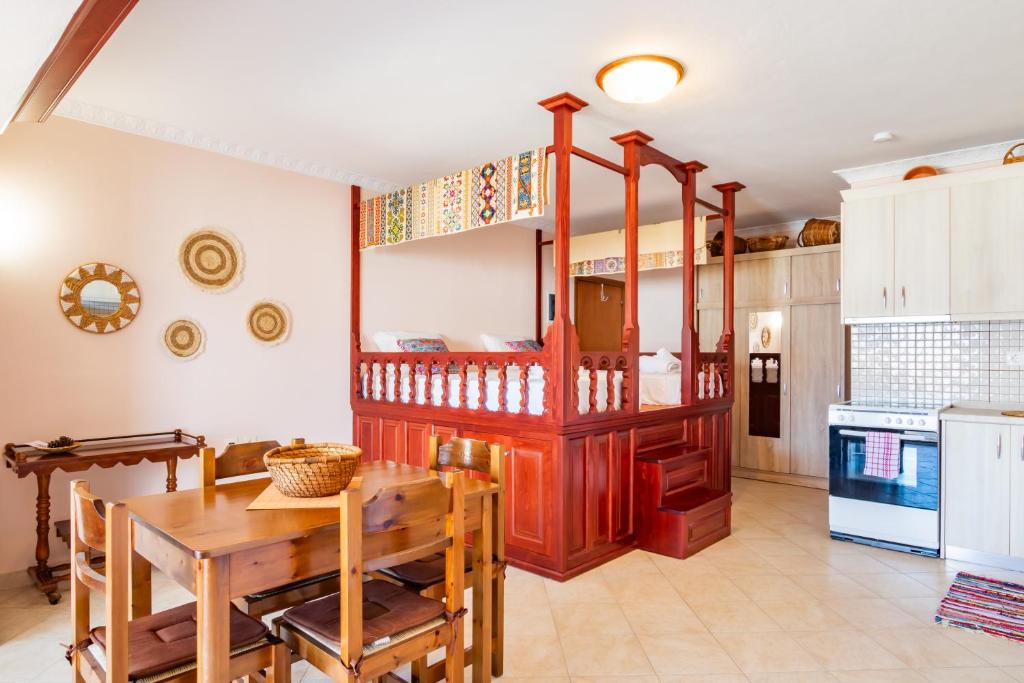 a kitchen with a table and a dining room at Maria's Studio 1 in Karpathos