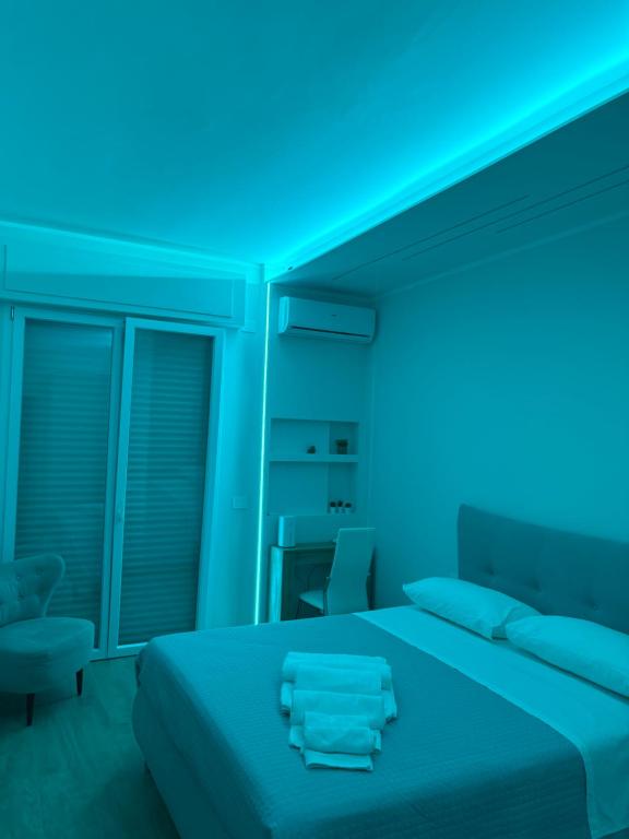 a bedroom with a bed with blue lights on it at Stazione 21 - Pescara Loft in Pescara