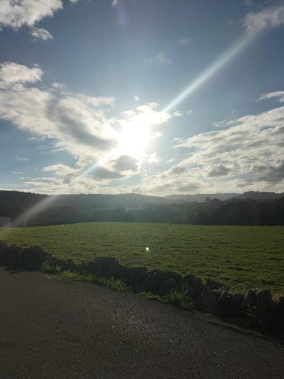 a view of a field with the sun in the sky at Casa Dulce in Villaviciosa