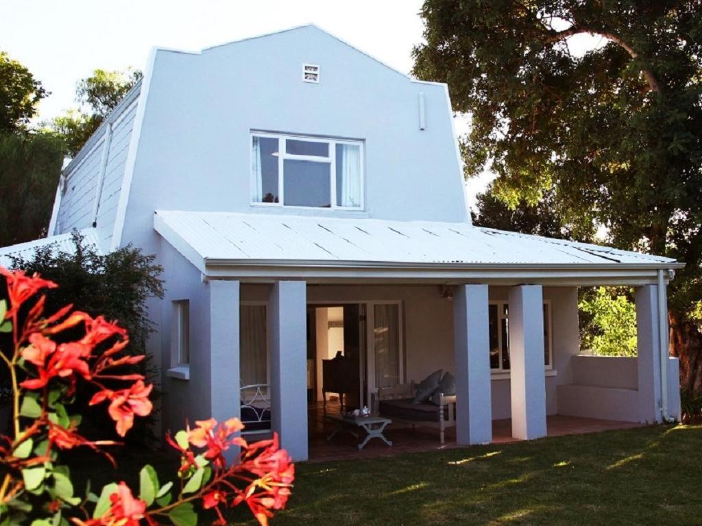 a white house with a window and a patio at The Ark Holiday Home in Stanford