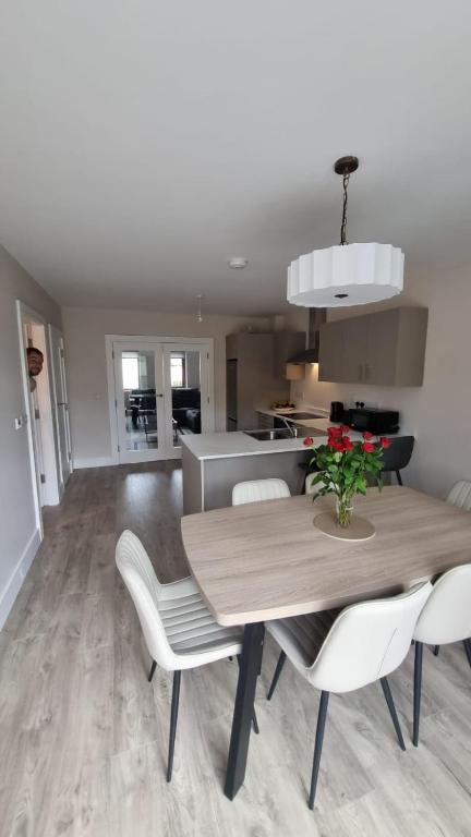 a dining room and kitchen with a table and chairs at Lidia House in Westport