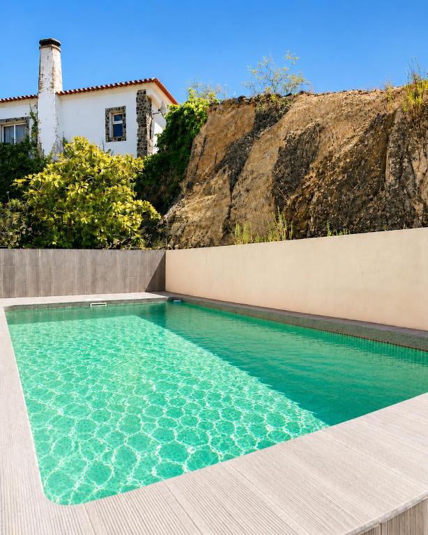 a swimming pool in front of a house at Pool&River Villa in Alcoutim