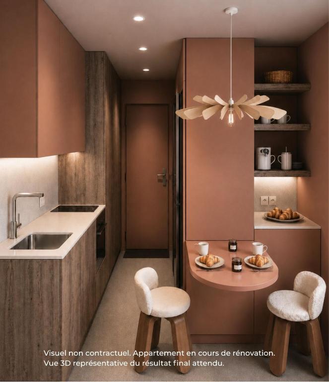 a kitchen with two stools and a table with a sink at Funiculaire collection in Tignes
