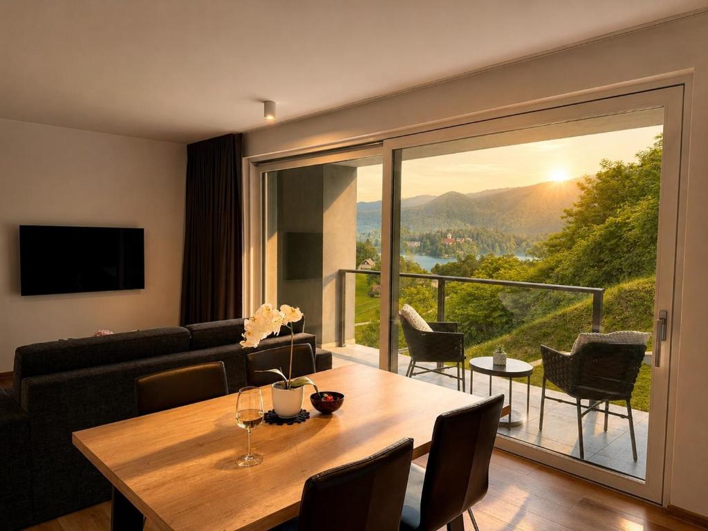a living room with a table and a large window at Vila Katarina - Lake View Apartments in Bled