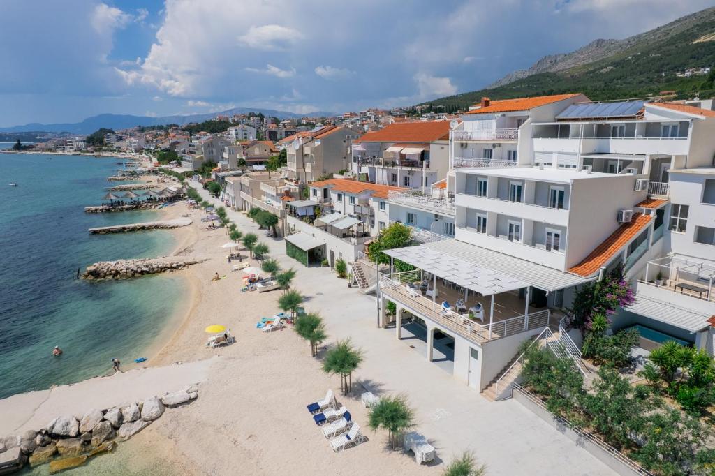 an aerial view of a beach and buildings at Villa Victoris Beachfront Luxury Villa with Heated Spa Pool Podstrana in Podstrana