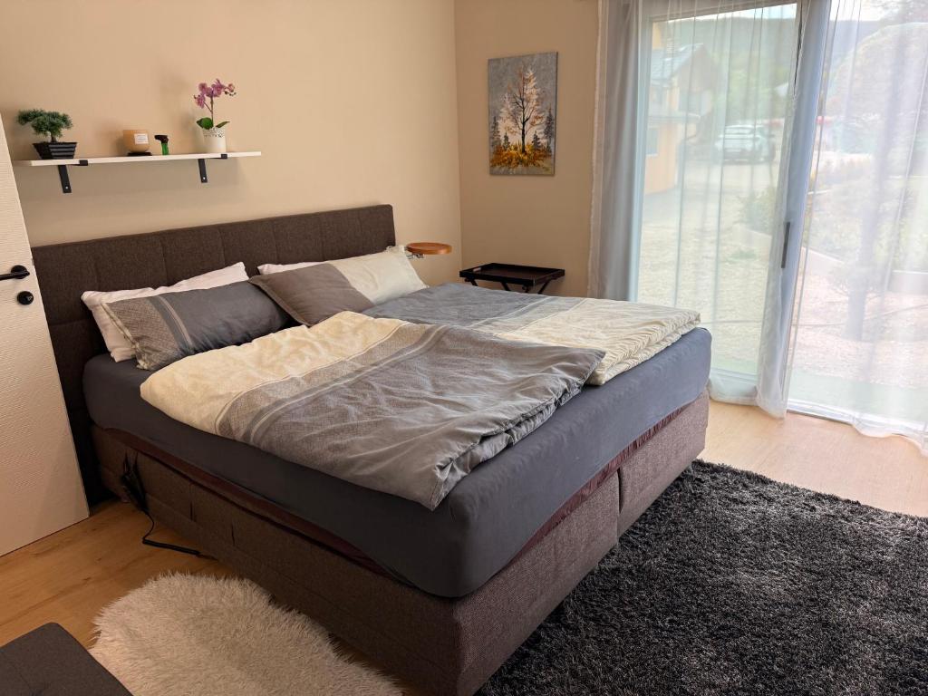 a large bed in a bedroom with a window at Privatroom for rent in Bad Fischau