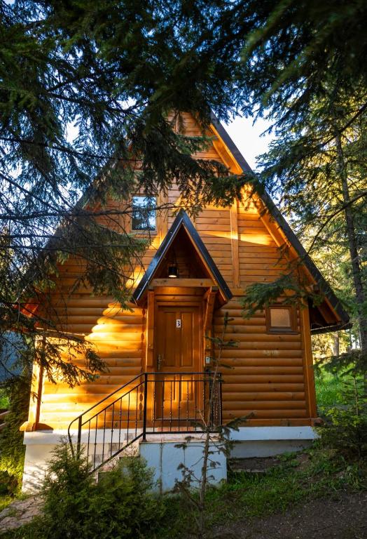a log cabin with a balcony in front of it at Zlatar Zen Chalet in Vukovina