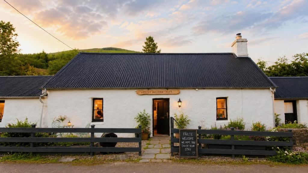a white house with a black roof at Wester Auchraw Croft B&B in Lochearnhead