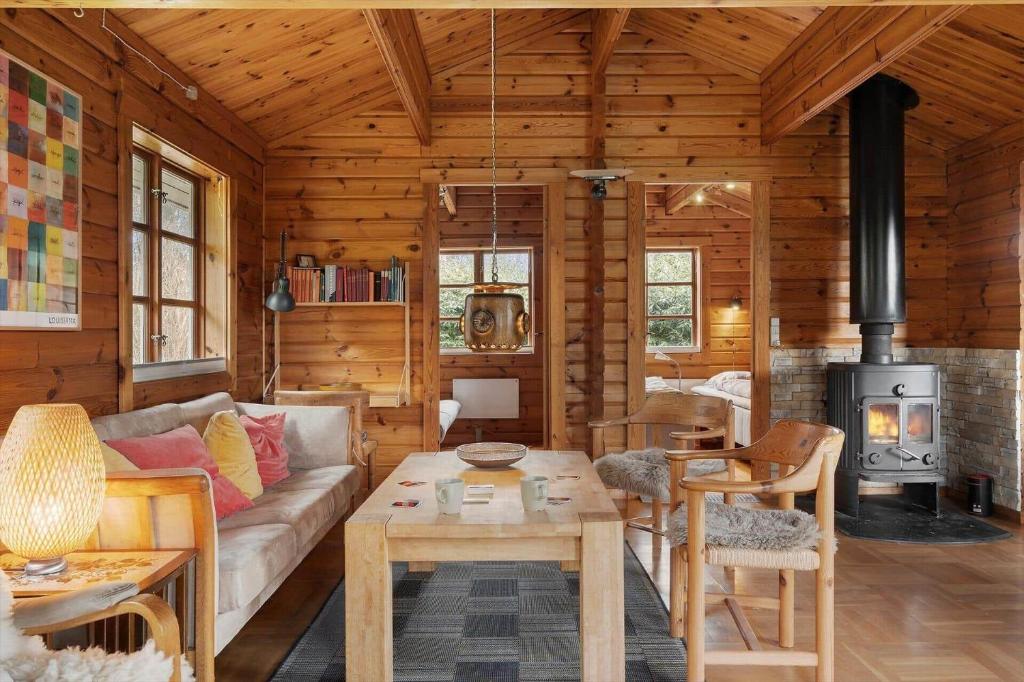 a living room with a couch and a stove at FJ4306-Oro-Skovhojgardsvej-3 in Orø