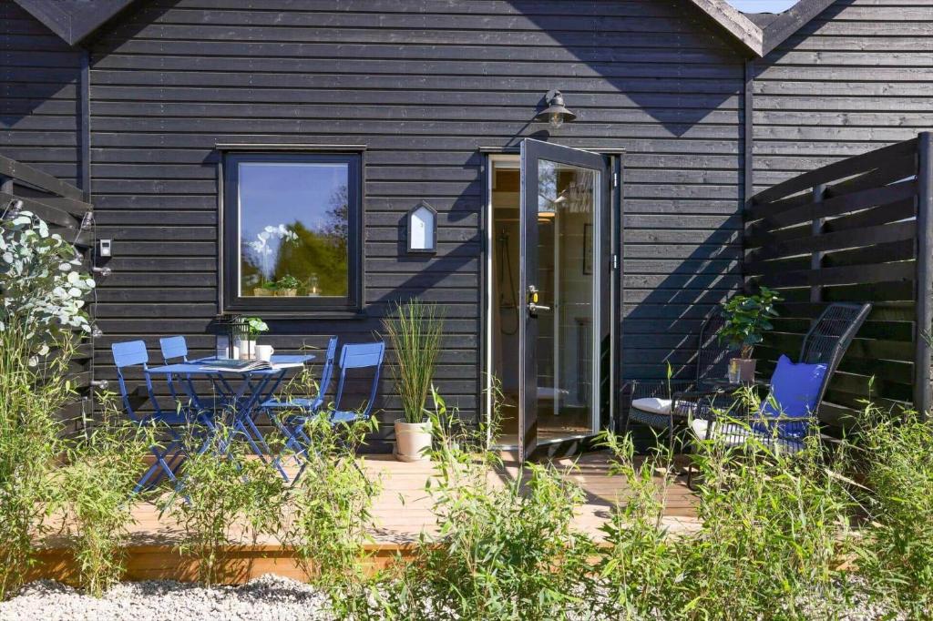 a house with a patio with a table and chairs at 13502-Vig-Lyngvej-107-3 in Vig