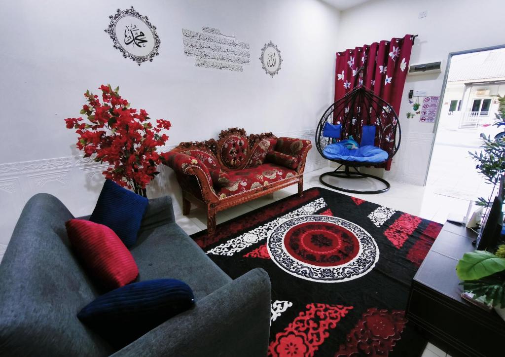 a living room with a couch and a table at Cozystayz NuNa in Sitiawan