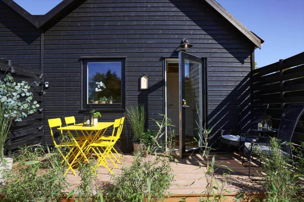 a patio with a yellow table and chairs in front of a house at 13504-Vig-Lyngvej-107-5 in Vig