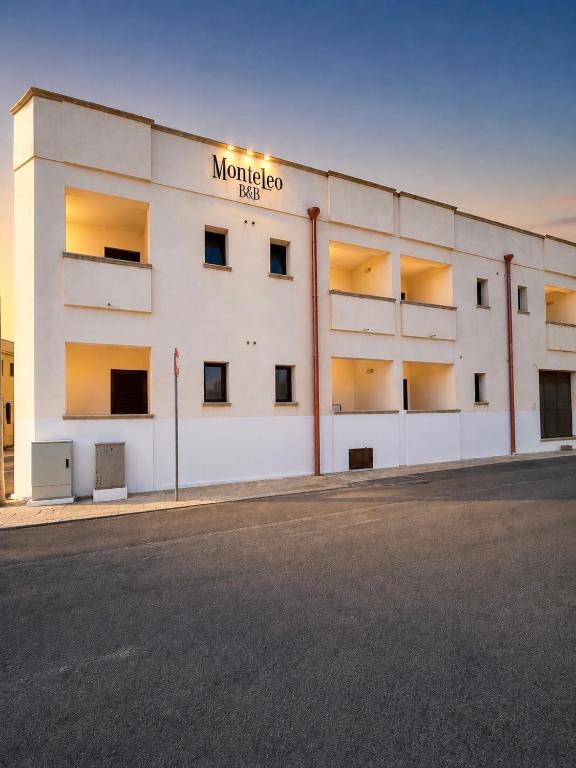 a white building with a sign on the side of it at B&B Monteleo Salento in Morciano di Leuca