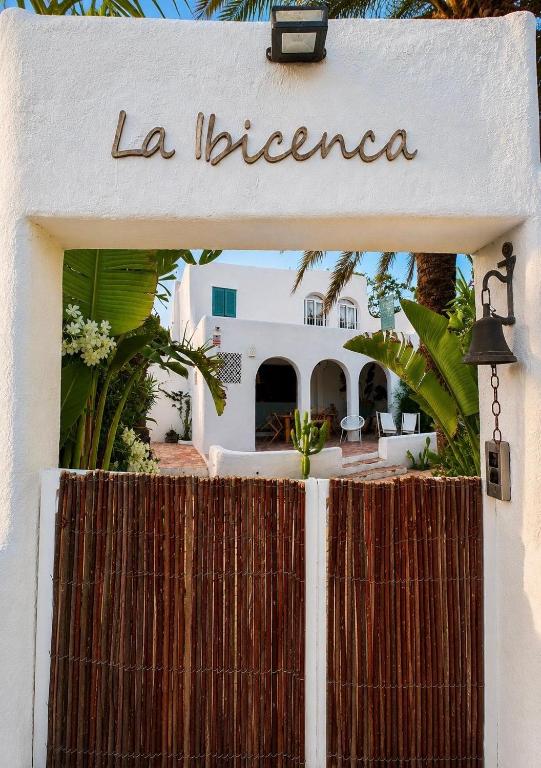 a white building with a sign that reads la libertera at La IBICENCA & JACUZZI by XimoApartments in Oliva