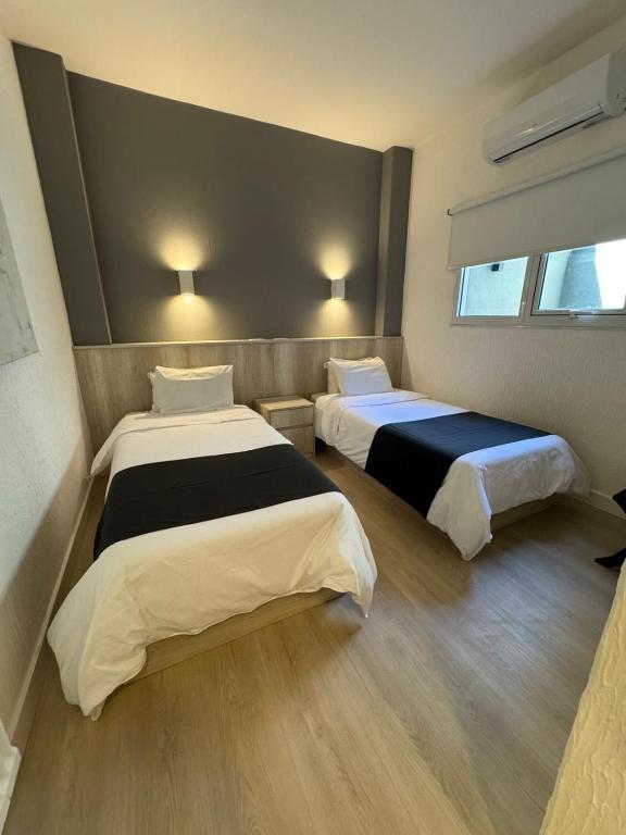 a room with two beds and a window at Hotel República in Villa María