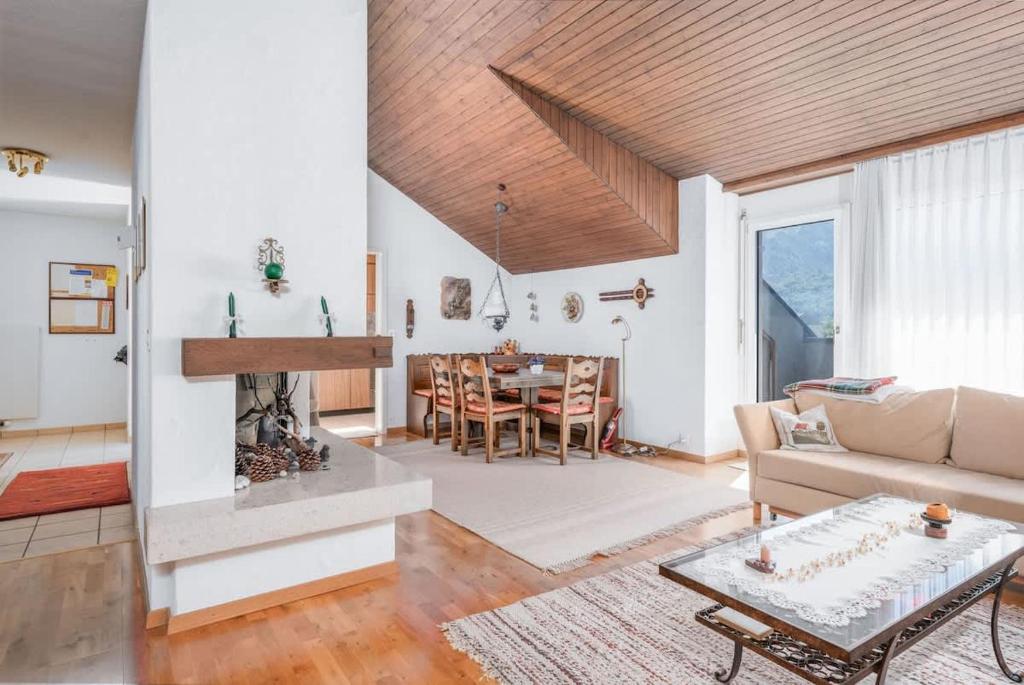 a living room with a couch and a table at Charming Alpine Apt with View 5min to Interlaken Ost in Interlaken