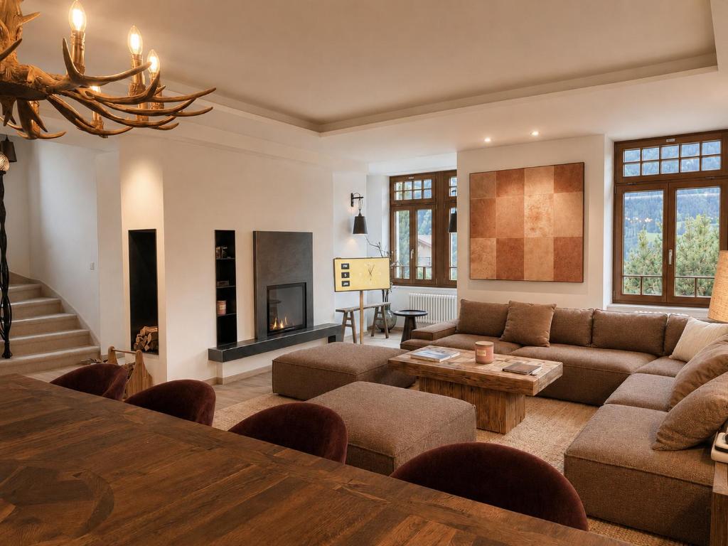 a living room with a couch and a table at Villa Flora 1909 - Private Alpine Residence in Grindelwald
