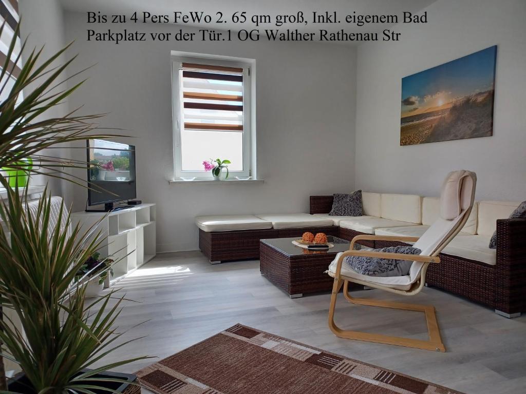 a living room with a couch and a chair at FeWo s Runde Wiese WR in Greifswald