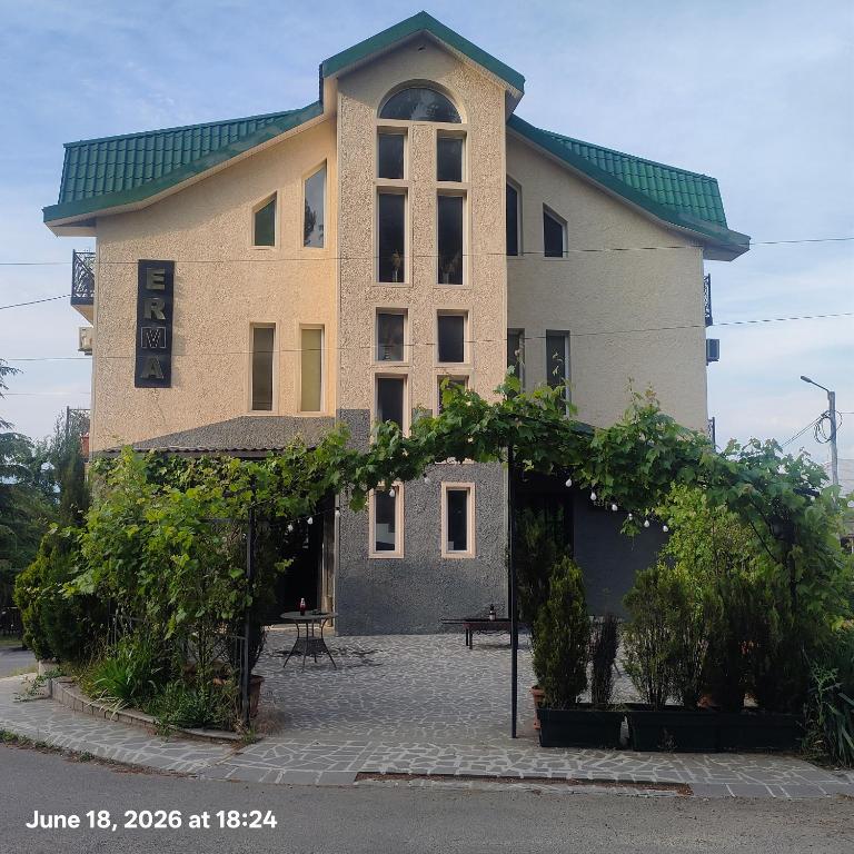 a large building with a green roof at Telavi ERMA in Telavi