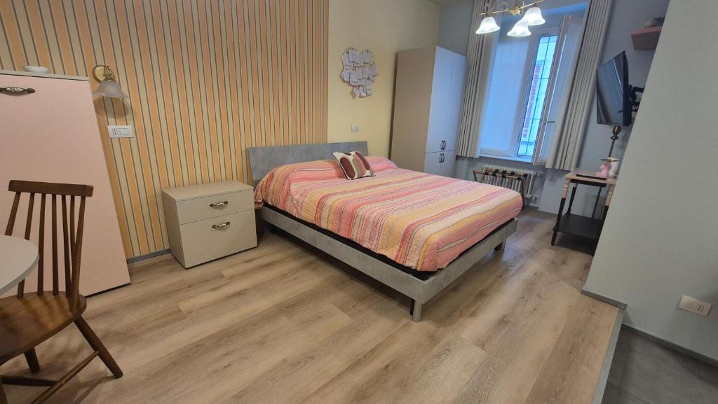 a bedroom with a bed and a table and a chair at MoMa Home Villasanta Monza Park in Villasanta