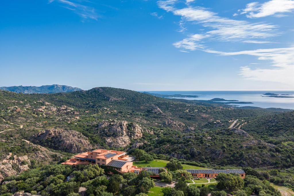 an aerial view of a building on a mountain at Hotel Rocce Sarde in San Pantaleo