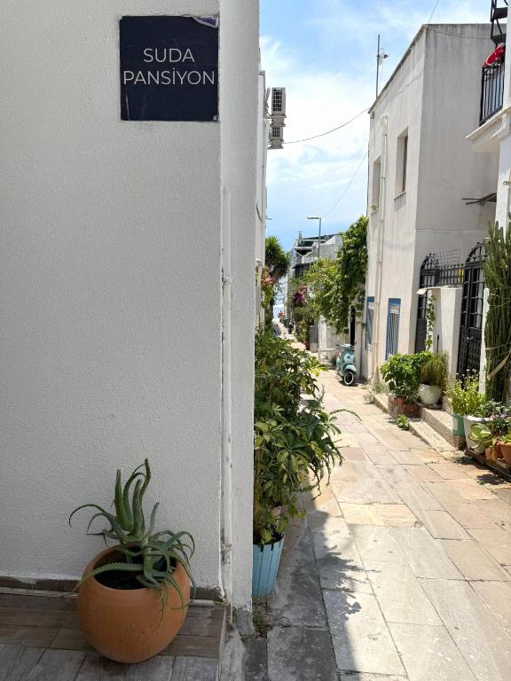 a street with a sign on the side of a building at Suda Pansiyon in Bodrum City