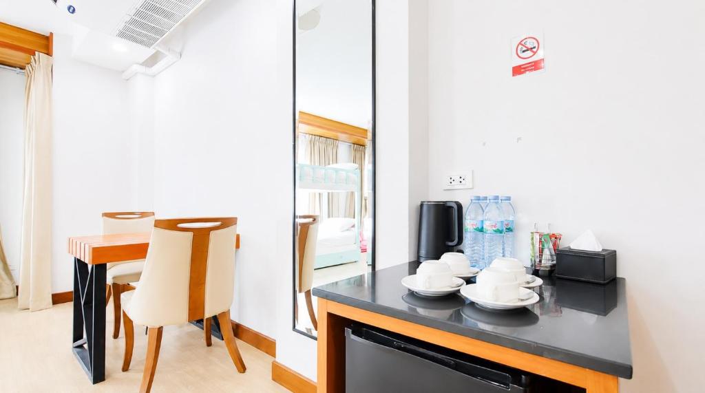 A compact in-room refreshment station beside a small dining table.
