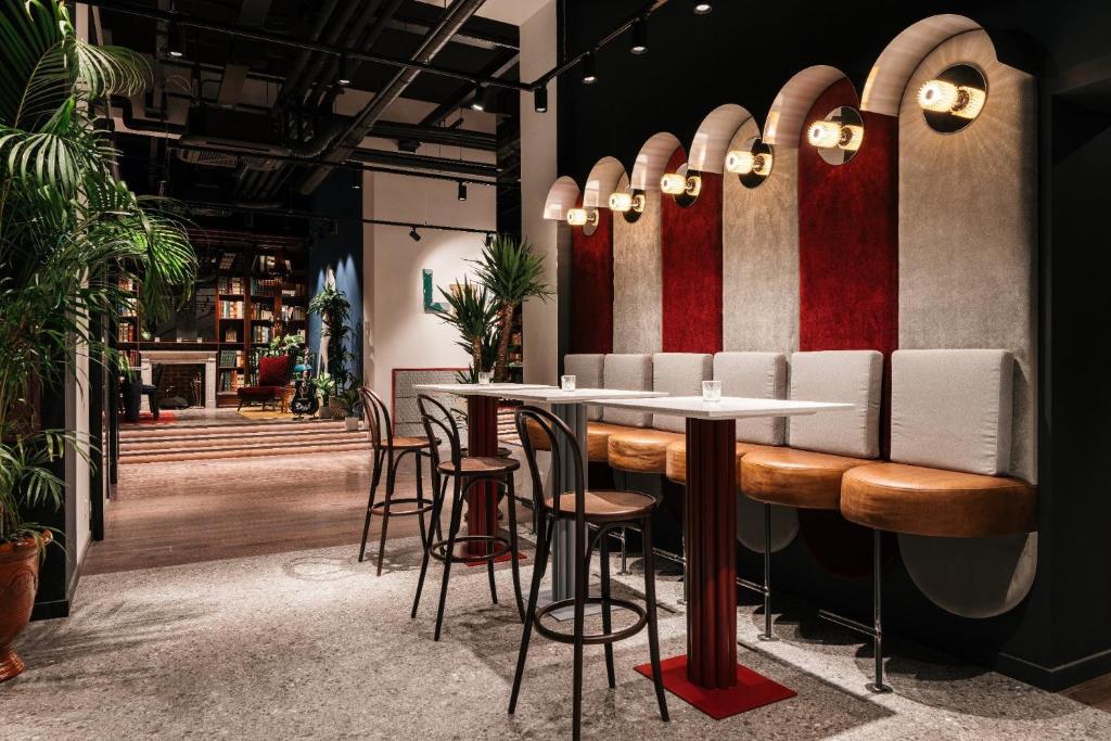 a restaurant with a bar with stools at Ruby Lilou Hotel Marseille by IHG in Marseille