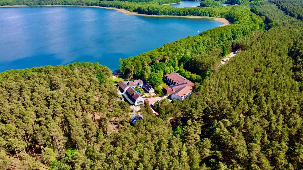 an aerial view of a house on a hill next to a lake at Familotel Borchards Rookhus in Wesenberg