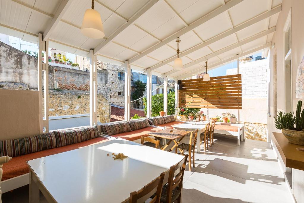 a restaurant with tables and chairs and windows at Rethymno Youth Hostel in Rethymno