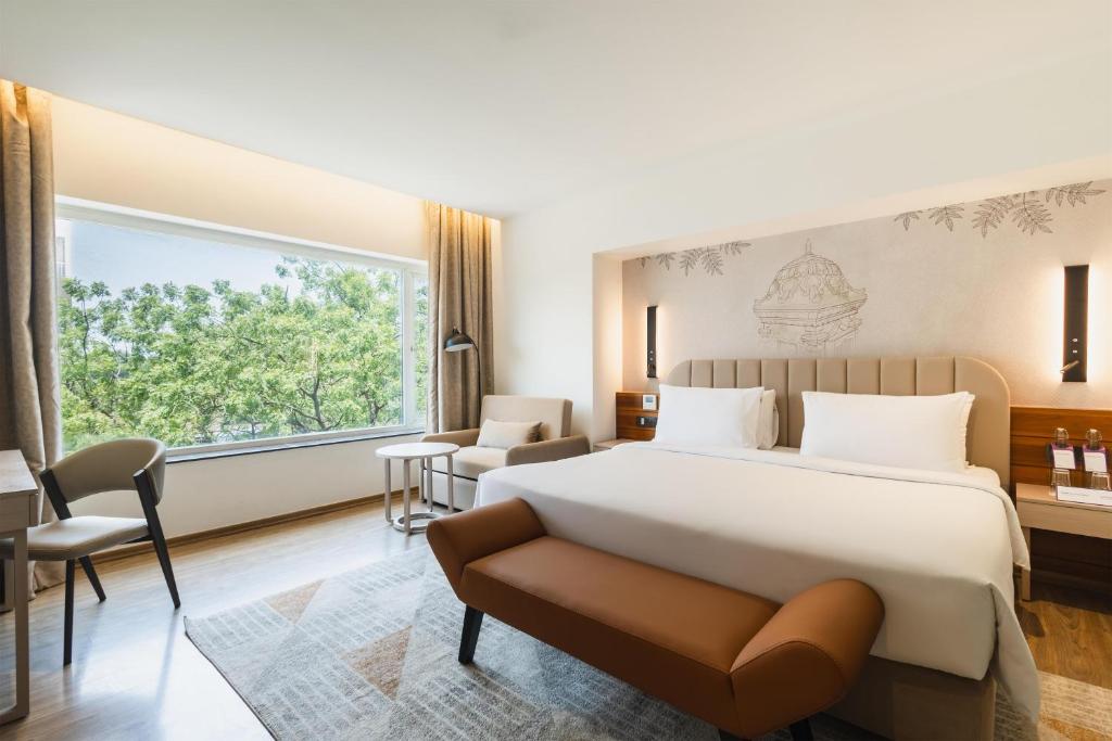 a hotel room with a bed and a window at Temple Tree Hotel Shirdi, a member of Radisson Individuals in Shirdi
