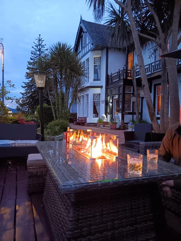 a fire pit in front of a house at Battery Lodge in Rothesay