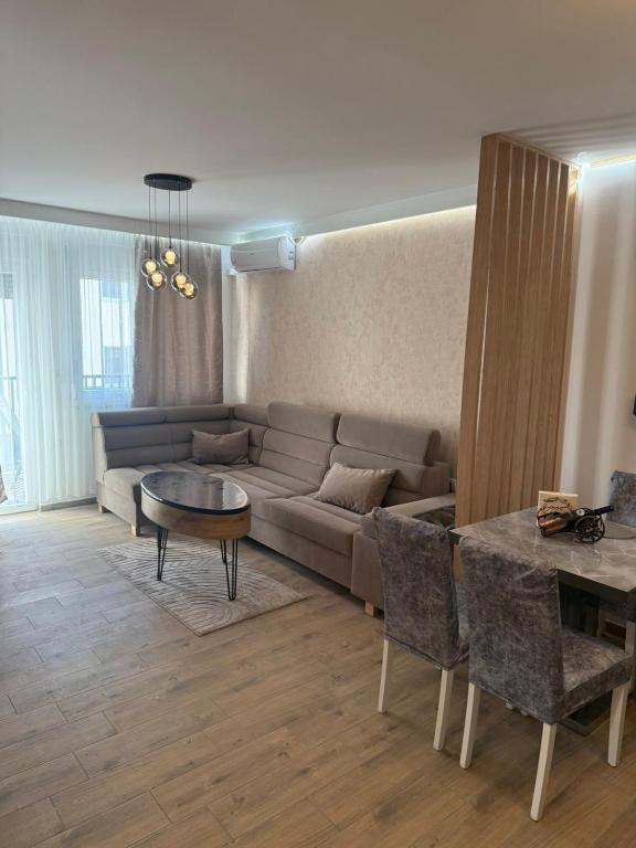 a living room with a couch and a table at Aurora Lux Wellness & Spa in Veliko Gradište