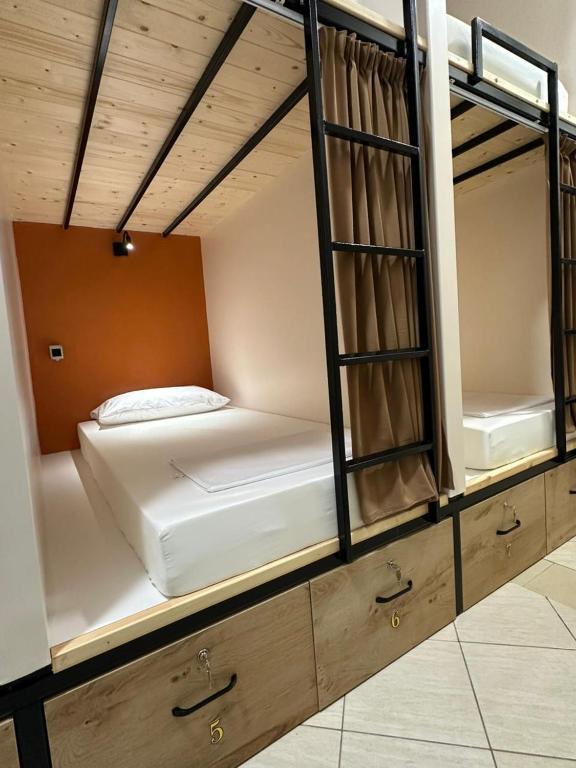 a room with two bunk beds on display at Queen-V Hostel in Vlorë