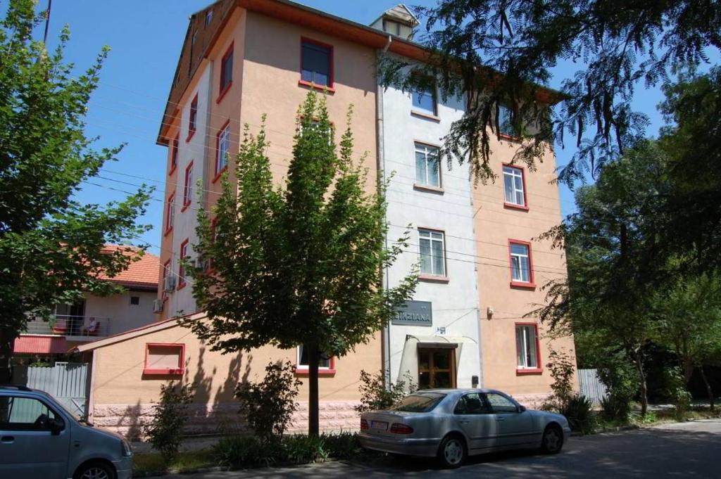 a building with a car parked in front of it at Sinziana Eforie Sud in Eforie Sud