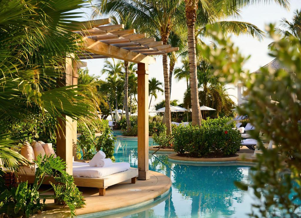 a pool with a pergola next to a resort at Rosewood Baha Mar in Nassau
