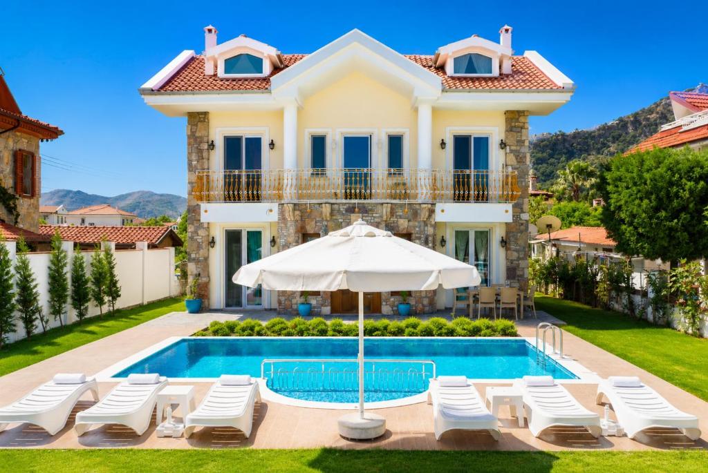 a villa with a swimming pool and a house at Villa Portakal Blossom in Dalyan