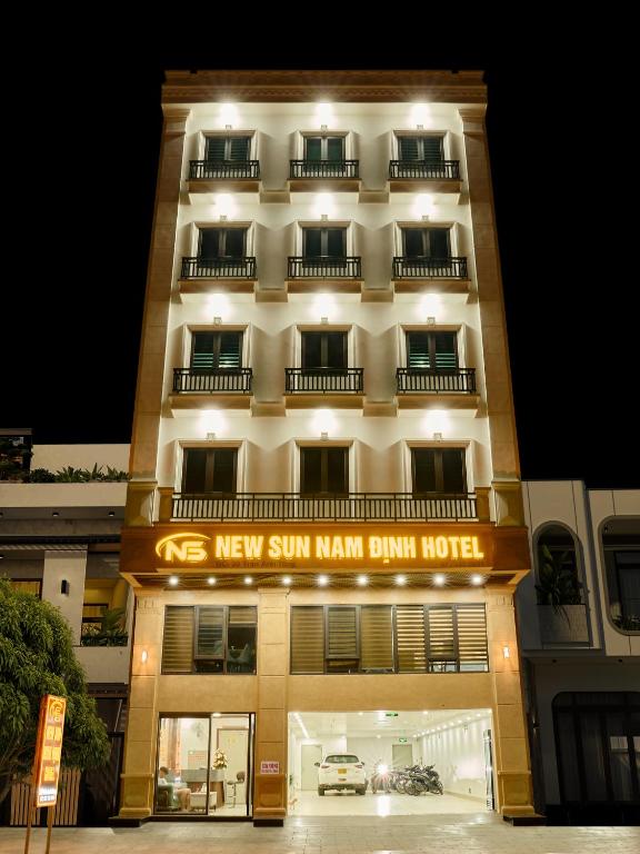 a building with a sign that reads new sun man man drum hotel at NEW SUN NAM ĐỊNH hotel in Nam Ðịnh