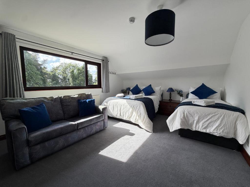 a living room with two beds and a couch at Tullyeskar House - Monasterboice in Philipstown