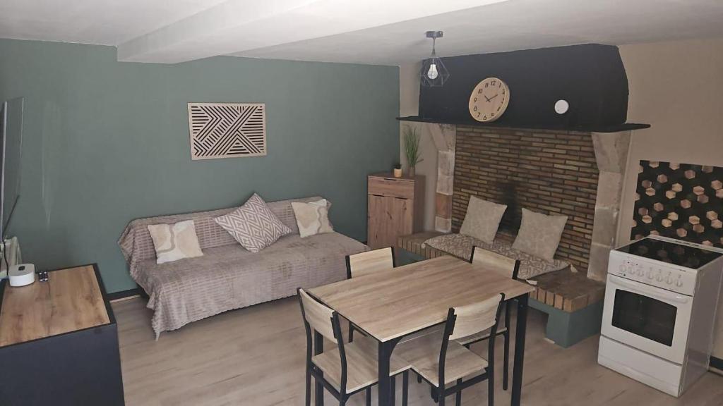 a living room with a couch and a table at Maison du golf in Nassigny