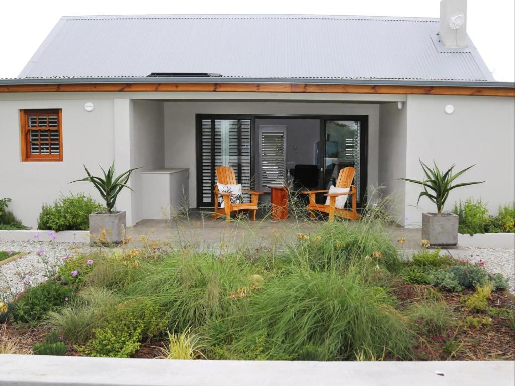 a house with orange chairs in front of it at 40 on Longmarket in Stanford