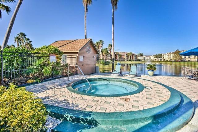 a small swimming pool in a yard with a house at Villa del Sol Condo,inum in Kissimmee
