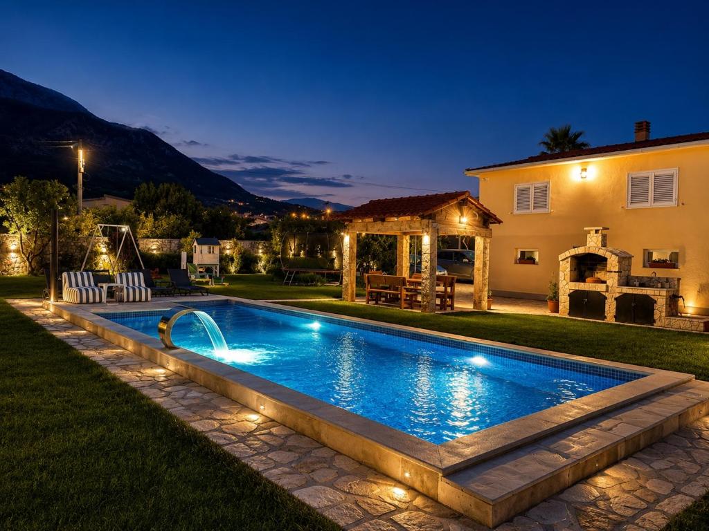 a swimming pool in the yard of a house at night at La Hacienda Percobic-Serenity & private pool in Bar