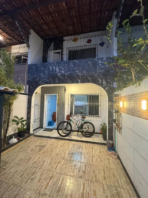 a bike parked in the front of a house at Espaço rosa mar in Aracaju