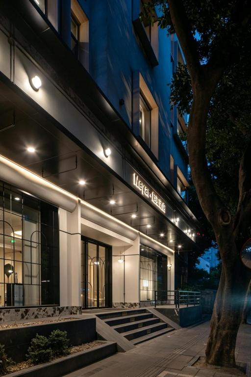a lit up facade of a building at night at Neyar Luxury and Tranquil Aesthetics Hotel-Prime Location,8-min Walk to Chunxi Road & Sino-Ocean Taikoo Li in Chengdu